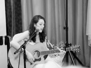 Karen playing the guitar on her wedding day | April Wedding