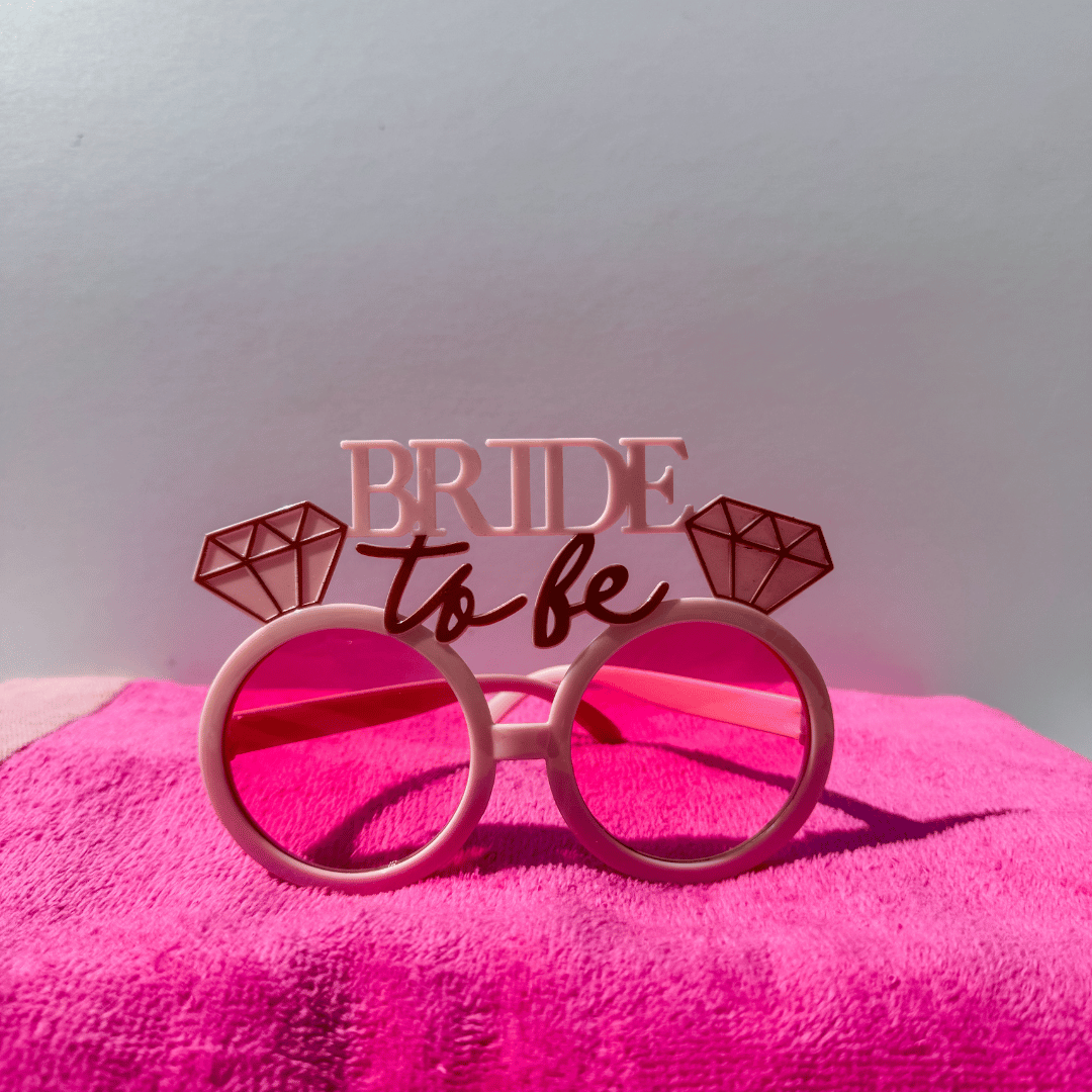Destination Bride Box gift set with bride cap, pink bride sunglasses and pool accessories for destination weddings