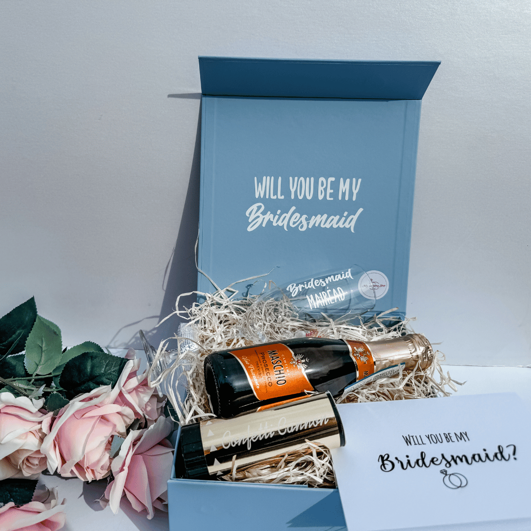 Luxury pale blue bridesmaid proposal box with personalised champagne flute, mini prosecco and proposal card.